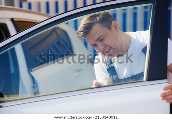 self-service car wash. a man\
washes the car window. professional cleaning of transport. car\
washer.