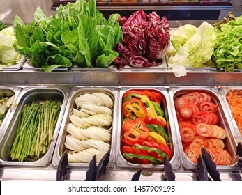 Self-serviced salad bar counter. Ready to eat vegetable be prepared in separate stainless box. Customer can choose mixed salad in one portion. Healthy and tasty food and good to your body.  - Shutterstock ID 1457909195
