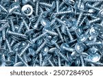 Self-tapping screw made of zinc metal texture background texture. Macro shot self-tapping screw pattern