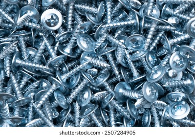 Self-tapping screw made of zinc metal texture background texture. Macro shot self-tapping screw pattern