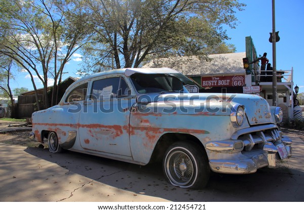 SELIGMAN, ARIZONA - AUGUST 16, 2014: Old car parked\
on the Mother Road, on August 16, 2014 in Seligman, AZ. Seligman is\
famous as origin of Route 66 and inspiration for the town of the\
movie Cars.