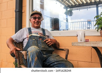 Seligman, Arizona, USA - August 22nd 2020 : Truck Driver Having A Break On His Drive On Route 66. Drinking A Cup Of Coffee And Smoking A Cigaret 