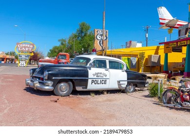 Seligman, USA - May 25, 2022: Vintage Historic Police Car At A Shop And A Route 66 Souvenir Shop In Seligman, USA.