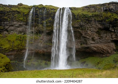 Seljalandsfoss, Iceland - Aug 22 2022: A Step Away From The Ring Road, Seljalandsfoss Is Born, A Waterfall Over 60 Meters High Located In An Unparalleled Landscape.