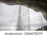 Seljalandsfoss Iceland is a stunning waterfall that allows visitors to walk behind the cascading water