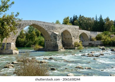 Seljuk Bridge in Aspendos. The Eurymedon Bridge. Turkey. Crooked bridge. An ancient building across the Kopruchay river. The bridge is built of large stone blocks and has five arches

