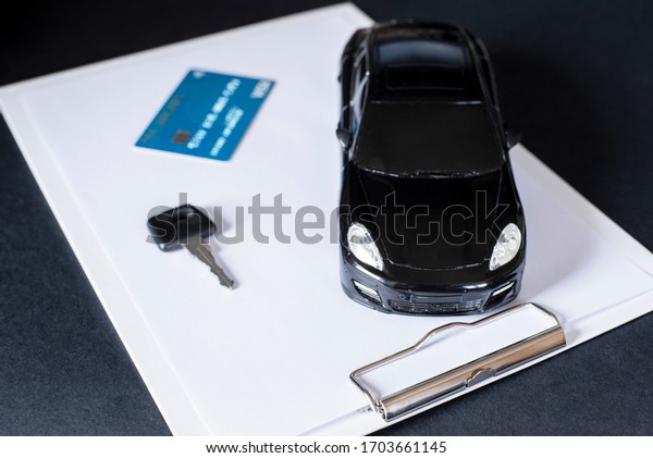 Sell, buy, rent, search for cars.\
Clipboard, key, credit card and black car.\
Concept.