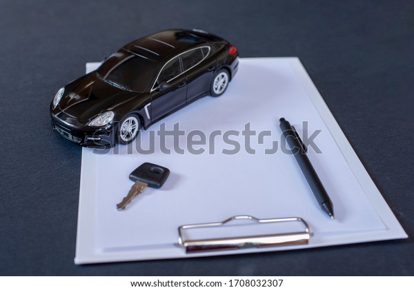 Sell, buy, rent, search for cars. Clipboard,\
key, pen and black car.\
Concept.