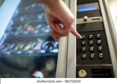 sell, technology and consumption concept - hand pushing button on vending machine operation panel keyboard - Shutterstock ID 581723635