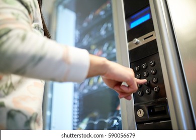 sell, technology and consumption concept - hand pushing button on vending machine operation panel keyboard - Shutterstock ID 590056679