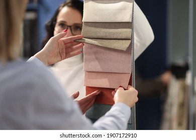 Seller And Buyer Choosing Fabrics For Curtains In Catalog Closeup. Design Work Concept