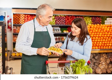 Seller And Customer At A Food Tasting As A Service In The Supermarket