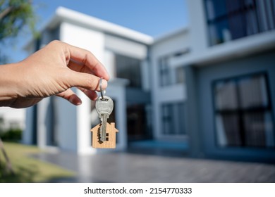 Selling Home ,Landlord And New Home. The House Key For Unlocking A New House Is Plugged Into The Door. Mortgage, Rent, Buy, Sell, Move Home Concept