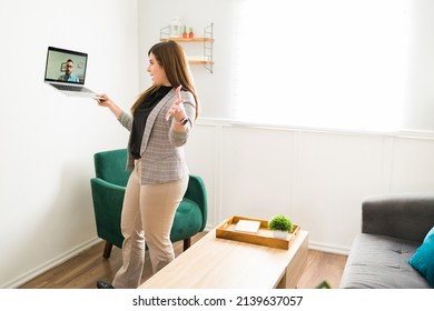 Selling A House. Female Real Estate Agent Using A Laptop To Give A Virtual Property Tour To A Client 