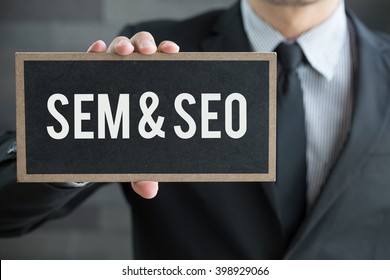 SEM And SEO, Message On Blackboard And Hold By Businessman
