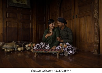 Semarang, Indonesia December 15, 2018 : a pair of lovers wearing Javanese batik striated clothes are playing old school games batik lurik