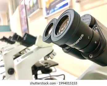 Semarang, Indonesia - June 20, 2021: Science Microscope On Lab Bench. Microbiology Laboratory. Blue Toned Image Of Binocular Microscope. Water Sampling Procedure For Microbiological Analysis