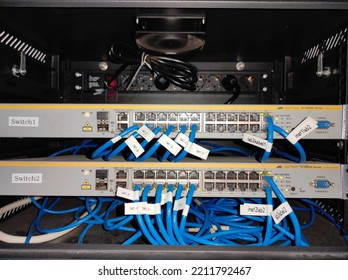 Semarang, Indonesia - October 9, 2022: Details Of The Blue Category 6 UTP Internet Data Cable With Two Stacked Switches And Labeled