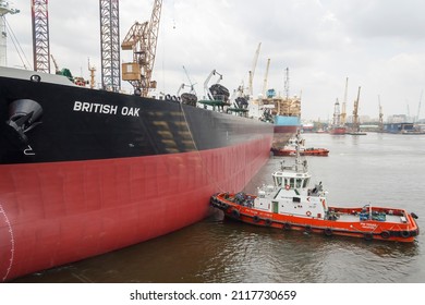 Sembawang, Singapore - March 10 2013: Multiple Tugboats Assisting Crude Oil Tanker 