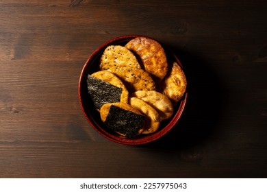 Sembei on the table. Sembei is a Japanese snack. A picture of Japanese image. A view from above. - Shutterstock ID 2257975043