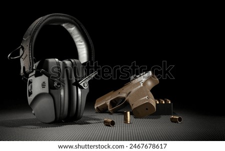 Semi automatic 8 mm handgun with electronic hearing protection with copy space