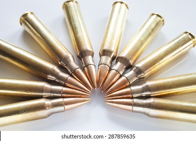 Semi circle of cartridges on white that have bullets with a steel core