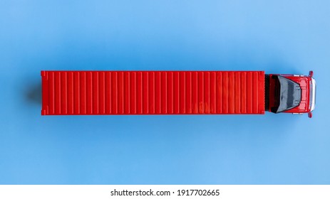 Semi trailer truck lorry container cargo vehicle on blue background, View from above, Aerial top view of semi truck with container cargo, Business logistic and transportation compay.