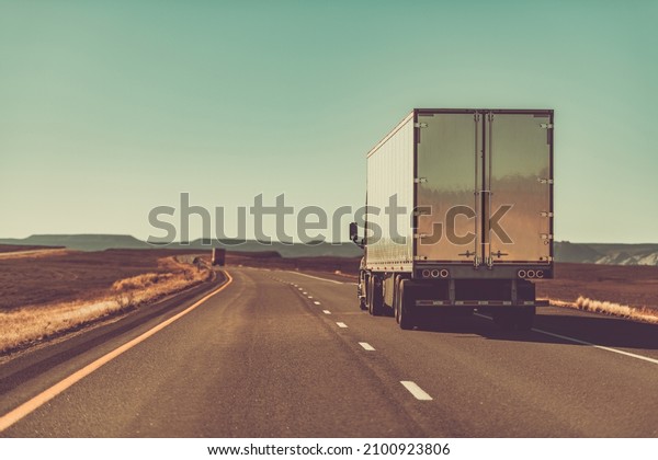 Semi Trailer Truck\
on an American West Route. Interstate I-70 Utah, United States of\
America. Rear View. 