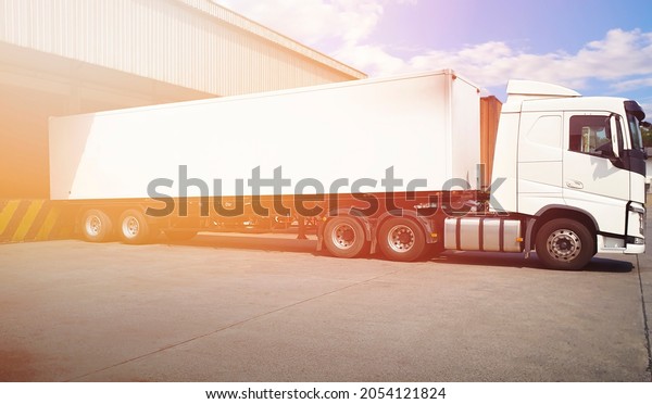 Semi Trailer Truck Parked Loading Package
Boxes at Dock Warehouse. Cargo Shipment. Industry Freight Truck
Transportation. Shipping Warehouse
Logistics.	
