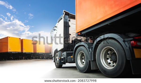 Semi Trailer Truck\
with Shipping Cargo Container Parking lot at a Blue Sky. Load\
Trucks Delivery Business . Industry Freight Truck Logistics Cargo\
Transport Concept.	\
