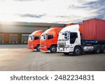 Semi Trailer Trucks on The Parking Lot at Warehouse with The Sunset. Distribution Warehouse Center. Truck Container Shipping. Freight Truck Logistics Cargo Transport.	
