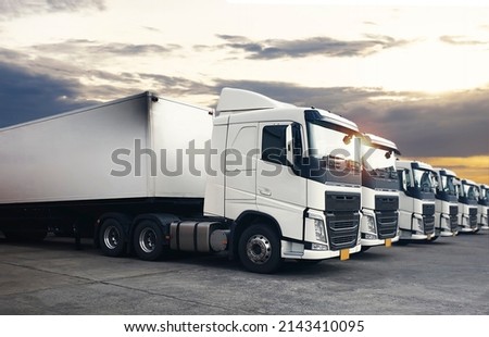 Semi Trailer Trucks The Parking Lot with Sunset Sky. Diesel Truck. Shipping Container Freight Trucks. Lorry. Trucks Logistics Cargo Transport.	

