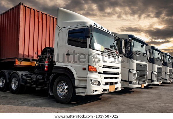Semi Trailer Trucks the\
Parking lot at The Sunset Sky. Delivery Trucks. Cargo Shipping.\
Lorry. Industry Freight Truck Logistics Cargo Transport. Auto\
Service Shop