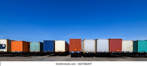 Semi Trailers Lined Up On The Ground With Blue Sky Background