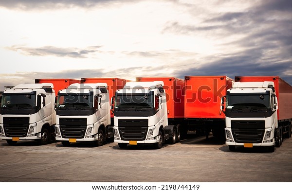 Semi\
TrailerTrucks Parked Lot with The Sunset Sky. Shipping Container.\
Delivery Transit. Engine Diesel Trucks. Lorry Tractor. Industry\
Freight Trucks Logistics Cargo\
Transport.