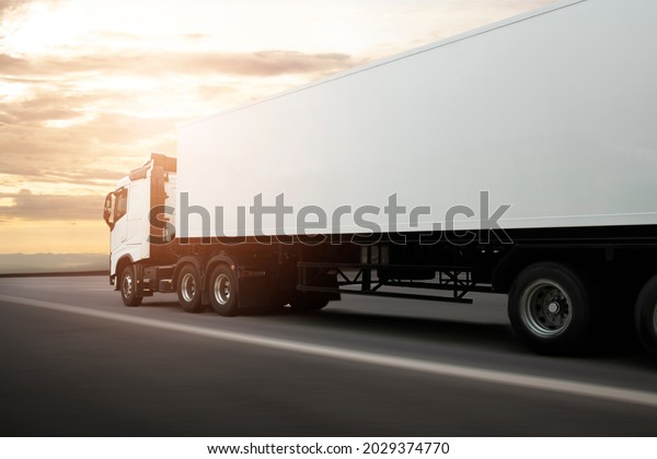 Semi Truck\
Container Driving on Highway Road with Sunset Sky. Delivery Truck\
Cargo Shipment Service. Industry Road Freight Truck. Logistics and\
Cargo Transport\
Concept.	\
