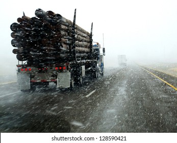 Semi Truck Driving Down Highway During Blizzard Snow Storm