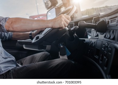 Semi Truck Driving Job. Caucasian Men Behind Semi Truck Steering Wheel. Cabin Interior. Transportation And Spedition Industry.