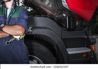 Semi Truck Mechanic Job. Caucasian Truck Service Technician With The Iron Wrench. Vehicle Maintenance Concept.