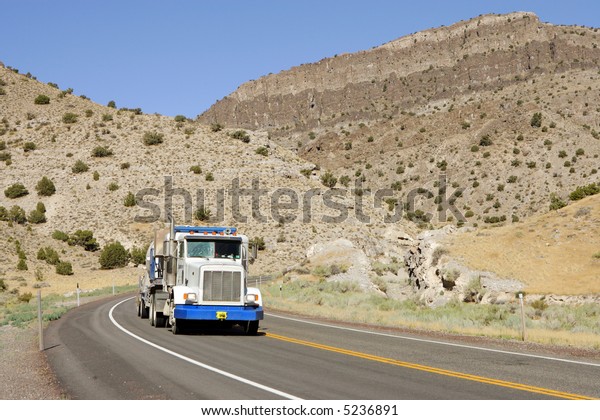 Semi\
truck on Deserted highway in high mountains,\
Utah