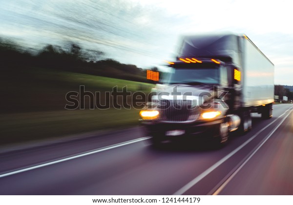 Semi truck on\
highway concept with motion\
blur	