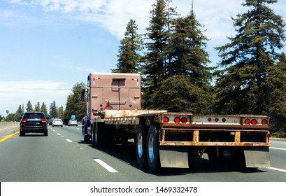 Semi Truck On Highway With Empty Flatbed Trailer.