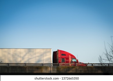 Semi truck on highway side view profile at sunset