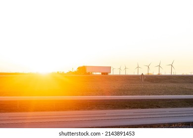 Semi Truck On Hiway Road. Sunset And Wind Turbines In Indiana