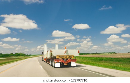 Semi Truck On The Road Transporting Oversize Load And Cargo