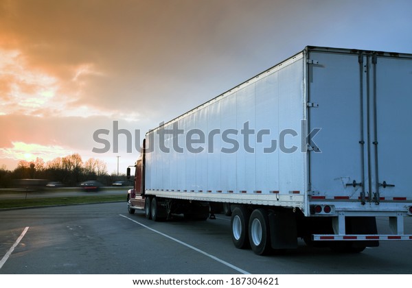 Semi Truck Parked on rest area. Sunset time -\
tobacco graduated filter\
used.