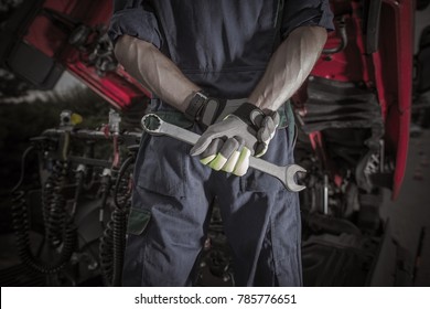 Semi Truck Pro Mechanic. Caucasian Service Worker With Heavy Duty Wrench Preparing For Complicated Truck Fix. 