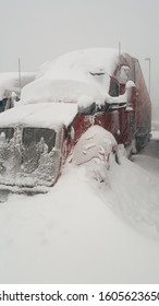 Semi Truck under snow on parking.