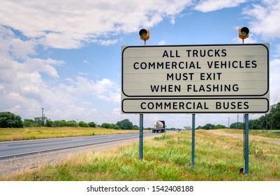 Semi Truck Weight Station Sign In Texas With Traffic Lights And Trucks Passing By / Commercial Vehicles Inspection Station Indicator