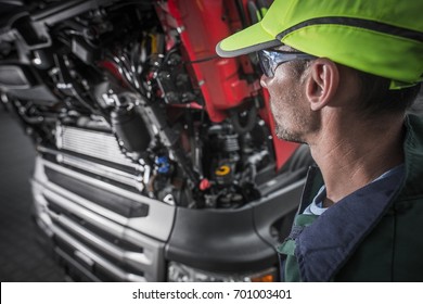 Semi Trucks Caucasian Mechanic Preparing For The Job. Truck Maintenance Concept Photo.